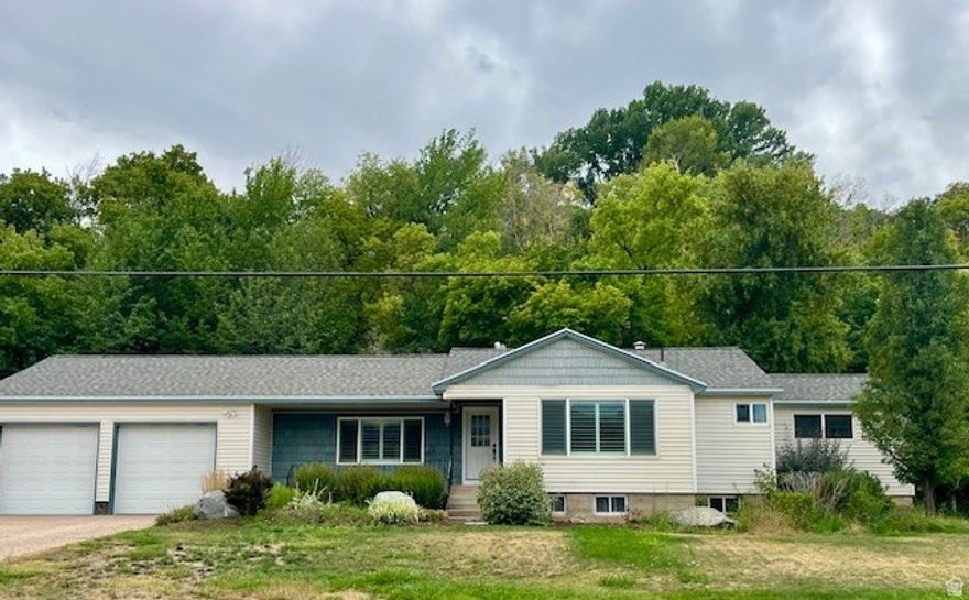 Secluded Single-Family Home on Large Lot with Oversized Shop & Mountain Views  Tucked away on a large peaceful lot, this private 4-bedroom, 3-bathroom single-family home offers the rare combination of space, seclusion, and versatility-without sacrificing comfort or views. With no close neighbors, this property is ideal for those seeking quiet living and room to breathe.  Built in 1950 the home features a thoughtful, well-designed layout with generous living areas that include granite countertops, double sink bathroom vanities & a sunken living room with french doors out to the picturesque backyard. Large windows throughout the home flood the space with natural light while framing beautiful mountain views.  Step outside and experience the true value of this property. The expansive lot provides endless opportunities-gardening, outdoor entertaining, or simply enjoying the open space and scenic surroundings.  Adding exceptional functionality is the detached oversized shop, ideal for hobbies, vehicle storage, a home business, or large projects that need serious space.