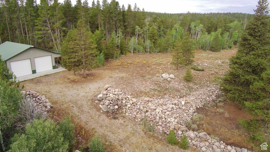 Year-round access in the Uinta Mountains! This prime lot is located right off of the plowed section of Mirror Lake Highway giving you access all year. The property includes a 48'x40' garage with a 12' overhang on the 48' side that makes an amazing patio or trailer parking. It also offers two 14' high x 12' wide garage doors that will easily accommodate a combination of RV, Snowcat, Boat, UTV's ...you name it. This is a fantastically well-kept building. The property itself, is flat with plenty of room to build or park trailers, and plenty of trees as well as cleared ground to give you the perfect start in building your mountain dream.  This property is currently outside of the Manor Lands Association, but buyer can choose to become part of the HOA and access through the gated community if preferred.