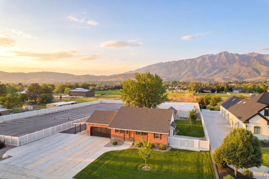 This is a truly unique property offering a rare combination of space, flexibility, and functionality with easy access to Timpanogos Highway and American Fork Canyon. The all-brick home has been well maintained and is in great condition, with updated landscaping, a maintained yard, and no unfinished projects or DIY work waiting for the next owner.  The property is fully fenced and zoned for horses, with significant parking capacity for 50+ vehicles, two additional storage sheds, playground equipment, trampoline, and basketball standard. Portions of the paved area could potentially be converted for animal use if desired.  One of the standout features is the detached workshop/man cave with approximately 1,952 square feet of additional space, including a 30x40 garage/workshop area, office space, bathroom with shower, kitchenette, additional flex room, and built-in storage shelving. The home also includes a separate basement entrance through the garage, creating potential for a future basement apartment or separate living space. Buyers are advised to verify ADU possibilities and commercial use/zoning opportunities with Highland City.