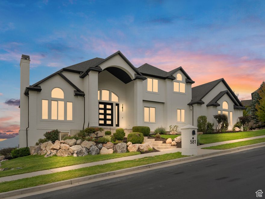Welcome to a fully reimagined luxury estate in one of Draper's most prestigious gated communities. Every element-from flooring and cabinetry to countertops, appliances, and lighting-has been hand-selected by a professional designer to create a home that feels cohesive, timeless, and tailored. Blending the feel of new construction with the prestige of an established location, this residence delivers a lifestyle of sophistication and comfort.  Set on a rare -acre flat lot along Draper's east bench, the property captures sweeping mountain and valley vistas that change with the seasons. The expansive grounds strike a balance between privacy and function, offering endless possibilities-whether it's a pool, a pickleball court, or your own vision of outdoor luxury. Large windows flood the home with light and frame sunsets that melt into twinkling city lights each evening. Just minutes away, discover Corner Canyon's trails, top-rated schools, Draper's dining and shopping, and the transformative Point development-Utah's next hub of innovation and entertainment.  Inside, CoreTec wide-plank flooring, bespoke cabinetry, designer lighting, and fresh finishes create a crisp, elegant atmosphere throughout. The gourmet kitchen features professional-grade appliances, quartz countertops, handcrafted cabinetry, and a spacious island flowing seamlessly into the living and dining areas with soaring ceilings. An entertainer's dream, the butler's pantry-with mountain views-feels like a private catering kitchen, complete with expansive counters, floating shelves, abundant storage, a second refrigerator, dishwasher, and built-in pebble ice machine.  The owner's suite is a private sanctuary, with dual walk-in closets (one with washer/dryer) and a spa bath featuring a freestanding soaking tub, dual vanities, and a Walker Zanger tiled shower with custom bench seating. A private terrace offers quiet mountain mornings and colorful evening skies. Six additional bedrooms provide flexibility for family, guests, or work-from-home needs.  The daylit full walkout basement extends the lifestyle with its own new kitchen, expansive living spaces, and a hidden room ideal for a wine cellar or secure vault. A fully remodeled ADU with private entrance provides options for extended family, guests, or rental income. Additional highlights include Trex decks designed for Utah's most stunning sunsets and a finished oversized three-car garage with abundant storage and workspace-ready to transform into the ultimate dream garage.  Few homes combine location, design, and function so seamlessly. This professionally curated estate offers the rare chance to own a property that lives like new construction without the wait. With its modernized interior, rare flat lot, daylit walkout basement, oversized garage, and gated setting, it was designed for those who value elegance, convenience, and true move-in-ready living. Schedule your private showing today and experience Draper luxury, completely reimagined.
