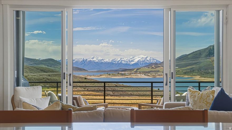 This thoughtfully designed, and extensively upgraded Shoreline townhome, completed in 2024, offers the perfect blend of modern design, comfort, and year-round adventure. Featuring four bedrooms and beautifully curated spaces, it is ideal for both everyday living and mountain getaways.  Located just minutes from Jordanelle Reservoir and a short drive to world-class skiing in Park City, the home is perfectly positioned for boating, fly fishing, hiking, biking, and four-season recreation.  Inside, clean lines meet warm finishes. The main level features engineered wood flooring and a striking stone fireplace with custom built-ins, creating an inviting space that flows seamlessly into the kitchen and dining areas. The kitchen is both refined and functional, with upgraded countertops, a large pantry, and thoughtful storage.  A wraparound deck with built-in heaters extends the living space outdoors, perfect for enjoying mountain evenings with views of Jordanelle Reservoir and Deer Valley.  The primary suite offers a private retreat with a spacious walk-in closet and a spa-inspired bath with double vanity, soaking tub, walk-in shower, and separate water closet. Additional bedrooms include a bunk room, a king en-suite, and flexible guest space.  The lower level is designed for entertaining, featuring a large family room with game area, a built-out theater room with surround sound, and a wet bar with wine fridge.  Additional features include a mudroom and laundry with built-ins, powder room, epoxy-finished garage with cabinetry and EV hookup, Sonos audio, ample storage, and programmable thermostats.  A turnkey mountain retreat offering elevated living and effortless access to Utah's outdoors.