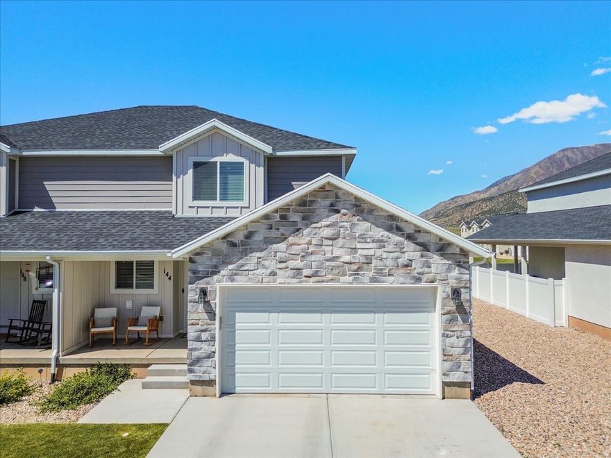 This beautifully maintained townhome features a fully finished basement, offering five bedrooms total and ample storage, and is conveniently located close to shopping with easy I-15 access for commuting. Set within a well-kept community that includes a playground while still offering a private feel, this south-facing 5-bedroom, 3.5-bath home delivers exceptional value with a thoughtfully designed layout to accommodate a variety of lifestyles. A newly finished basement adds two spacious bedrooms, a full bathroom, and a large storage room, providing flexible space for guests, a home office, hobbies, or additional living quarters. The main level is designed for gathering and entertaining, featuring an open-concept floor plan filled with natural light from large windows. Upgraded lighting, soft-close cabinetry, and quality finishes highlight the attention to detail throughout. The kitchen flows seamlessly into the living room and opens to a wraparound covered patio, creating easy indoor-outdoor living. Upstairs, the primary suite offers a comfortable retreat with a built-in reading bench, a large walk-in closet, double sinks, and tasteful finishes. Two additional bedrooms and a full bathroom complete the upper level. Main-level laundry and included kitchen appliances make this home truly move-in ready. Situated in a well-maintained community with attractive common areas, the HOA covers yard care and snow removal, allowing for a low-maintenance lifestyle. Meticulously cared for and in excellent condition, this townhome presents an outstanding opportunity to enjoy comfort, space, and convenience in a low-maintenance setting.