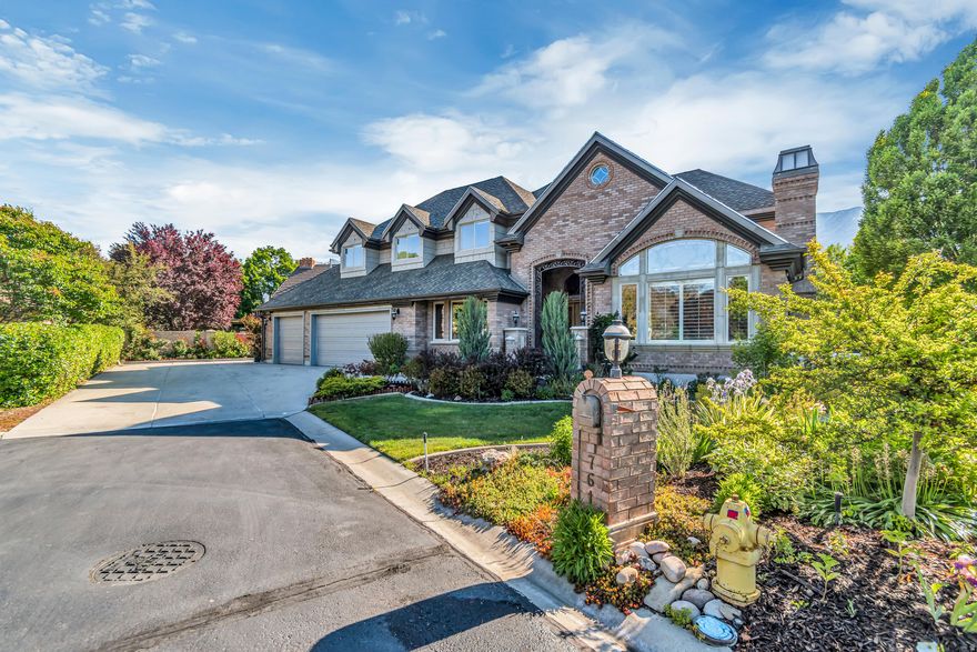 Discover the possibilities in this expansive 5,800+ sq. ft. custom home located in the highly desirable Scera Park South neighborhood. Showcasing breathtaking views of Mount Timpanogos, Y Mountain, Provo, and the surrounding valley, this property offers a rare combination of space, craftsmanship, and location. Thoughtfully designed with exceptional details throughout, the home features hand-carved wood finishes, artisan glass windows, steel and bronze railings, elegant marble and granite flooring, and a spacious living room highlighted by soaring 16-foot vaulted ceilings. With 7 bedrooms, 3 full baths, and 2 half baths, there is abundant room for family, guests, and flexible living spaces. Designed for both comfort and entertaining, this home includes a theater room, workout room, sauna, office/den, and a finished walkout basement complete with a kitchenette. The heated 3-car garage, double walk-in closets, high-end appliances, and recently updated heat pumps, furnaces, and water heaters add to the home's functionality and value. Situated on a generous 0.32-acre lot, the beautifully updated landscaping, newly refinished front and back walkways, and large covered patio with built-in BBQ completes an outdoor setting perfect for gatherings or relaxing while enjoying the scenery. Offering privacy with convenient access to local recreation, shopping, and amenities, this is a premier opportunity in a sought-after area. Buyer to verify all information. A must-see property!