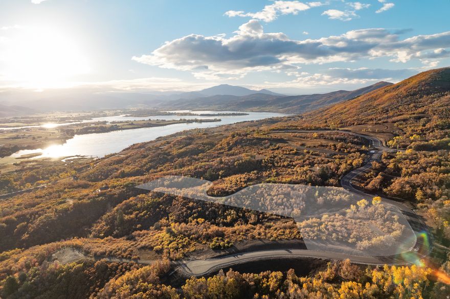 Welcome to Osprey Ranch - a 600-acre mountain ranch community set on the edge of Eden's unmatched four-season recreation. Tucked against 10,000 acres of protected national forest, this private enclave offers only 67 ranch estates across the mountainside overlooking the northwest shores of Pineview Reservoir. Lot 27 presents an opportunity to build your legacy home on one of Osprey Ranch's exceptional homesites. This beautifully wooded 9.57 acre lot sits along a peaceful stretch of the community with an elevated setting that opens to panoramic views of the Wasatch Range and the valley below. The natural topography and mature trees provide both seclusion and an ideal canvas for a mountain-modern residence. Outdoor recreation begins right outside your door. Minutes from the pristine waters of Pineview Reservoir, you'll enjoy boating, paddleboarding, and lakeside relaxation all summer long. Endless hiking and mountain-biking trails wind directly through Osprey Ranch, giving residents exclusive access to world-class terrain. When winter arrives, the Ogden Valley transforms into a snow-lover's paradise with Powder Mountain, Snowbasin Resort, and Nordic Valley all just a short drive away. And as the snow melts, you'll enjoy a 1-year complimentary Wolf Creek Resort Golf Membership, providing access to 18 spectacular holes surrounded by nature's best scenery. This is a fully improved lot, and water and sewer connection fees are already paid-a significant value for your build. Lot 27 at Osprey Ranch is more than land-it's the beginning of the mountain lifestyle you've been waiting for.