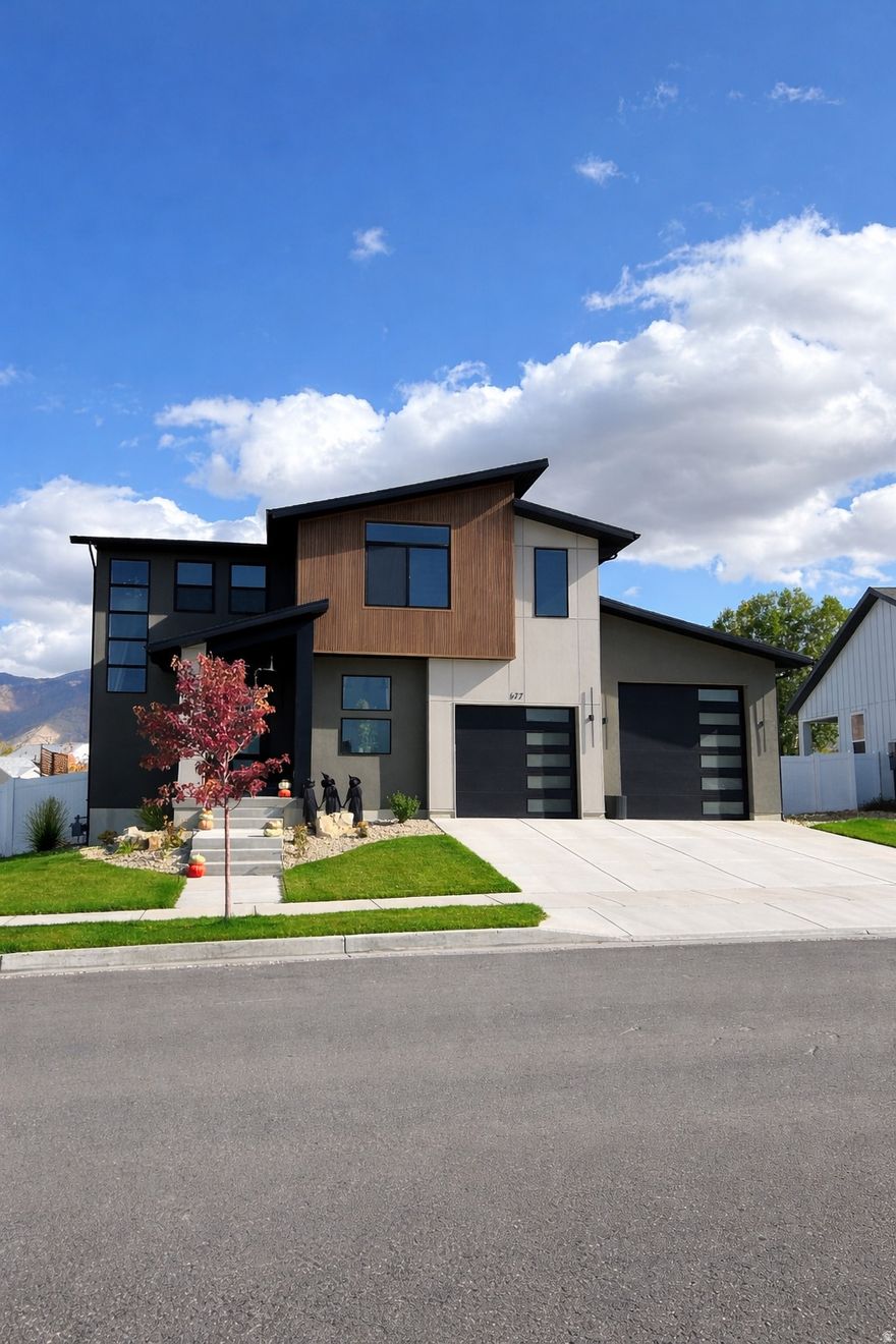 Stunning luxury modern home in one of Tooele's most desirable neighborhoods! Built in 2023, this meticulously maintained home offers 3,374 sq ft with 5 bedrooms plus 2 additional office/den/workout rooms, 3.5 bath, and a fully finished basement. The open-concept main level features a high-end kitchen with a walk-in pantry, dedicated coffee bar, quartz countertops, and all appliances included. Quartz countertop vanities elevate every bathroom throughout the home. Enjoy unobstructed mountain views in all directions and a beautifully finished backyard complete with patio, gazebo, storage shed, privacy fence, and concrete mowing curb. Front yard features an in-ground sprinkler system with gorgeous landscaping. Spacious garage includes boat/RV storage and is electric car charging ready. Designed for comfort with independent heating and cooling systems for main floor and second story. Located just minutes from England Acres Park. This home truly blends modern luxury, functionality, and location.
