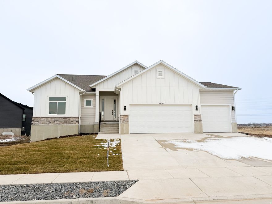 One of only a few homes remaining in the new and highly desired Macy Lane development, is our Hamilton Home that sits on the incredible corner of lot #18! With the spacious yard, partial front landscaping (coming soon) and views off the front porch looking at the Ogden Mountains & beautiful sunset views to enjoy off of the large covered back deck, this is a home worth visiting right away! Nearing completion in September, the home and all of its design/finishing touches will be coming together in these next few weeks!   With a large Master bedroom & on-suite bathroom + oversized walk in closet on one side of the house, and an additional 2 bedrooms on the other side of the main level, plus 2.5 baths, the home is set up with an ample amount of space for full living all done on the accessible main level. As soon as you walk in the front door, you are greeted with tall vaulted ceilings and a welcoming open family room and kitchen space perfect for entertaining.   As you make your way downstairs to the unfinished basement, you will be delighted to see an already constructed exterior basement walk out entrance for the home. The basement is thoughtfully designed to be finished off as a full use basement rental if desired or of course can be finished as additional living space to the overall home square footage.  We are more than happy to help you finish building your dream basement & I can quickly get estimated pricing for those inquiring so.   Lastly, a few more highlights to this home would be the oversized 3-car garage, NO HOA DUES at Macy lane, and each home on the lane is built semi to fully custom to create full versatility and value in Macy Lane.   Seller is currently offering $10,000 towards buyers concessions. Please call for details while offer lasts.