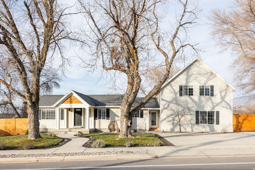 This bright, open, and inviting two-story home in Ogden was built in 1950, but it feels brand new throughout, thanks to plenty of thoughtful updates and a sizeable addition that came in 2005. The silhouette here feels very "modern farmhouse," and the interior is clean and well-designed, creating a property with plenty of ideal gathering spaces and lots of room for everyone you love to spread out and relax at just under 3,500 square feet. The primary living areas are brimming with natural light, and the aforementioned updates make for the perfect palette onto which you can create your ideal living space. The kitchen-also awash with natural light-includes new appliances, a peninsula, a pantry, and a large double-basin farmhouse sink, so convenience is the order of the day. A fireplace warms the generous living room that feels uncluttered, polished, and entirely relaxing. The primary suite is massive: high, vaulted ceilings lend an airy feel, a second fireplace anchors a sitting area and adjacent loft, and the en-suite bath feels modern and private. The back yard is expansive, to say the least, and a tiered layout offers endless possibilities, whether you're looking for room to practice batting/lacrosse, set up a garden, relax under the pergola, grill and dine al fresco, or cozy up around the firepit. A two-car garage marks the edge of the property to the side, where you'll find an additional grassy area and more gathering space. The neighborhood is quiet and the community small and friendly, so you may never leave, but with easy access to I-84, Highway 89, a handful of ski resorts, and the SLC airport, your options are wide open.