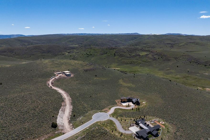 Rare opportunity to own 7.36 acres within the exclusive gates of Victory Ranch. This premier homesite offers a large, easy-to-build pad with the ability to construct up to a 9,000 sq ft residence with a generous 35-foot height allowance. Capture sweeping views overlooking 3,500 acres of pristine backcountry, creating unmatched privacy, serenity, and endless recreation right outside your door. A truly exceptional setting to build a legacy mountain retreat for you and your loved ones.  Victory Ranch is a private, four-season community amidst 6,250 pristine acres along four miles of the Upper Provo River. Amenities include an 18-hole Rees Jones golf course, world-class fly-fishing, miles of mountain biking and hiking trails, 5-stand shooting facility, 4x4 adventures, snowmobiles, ice skating rink, backcountry yurts, fishing ponds, multiple restaurants, a ski-in/ski-out lodge in Park City and more than 3,500 acres of untouched backcountry. The Post Clubhouse includes our concierge, heated pool, hot tubs, fire pit and Outfitters Store. Our Barn amenity features a Pizza and Ice Cream Parlor, Art Studio, Game Room and Indoor Basketball and Sport Court as well as a Fitness Center, Spa and Juice Bar. The swimming pool, waterslide, tranquil stream and pond, tennis, pickle and paddle courts, and event lawn will be sure to provide hours of family fun. Victory Ranch is approximately 15-minutes from Deer Valley and 25 minutes to Park City.