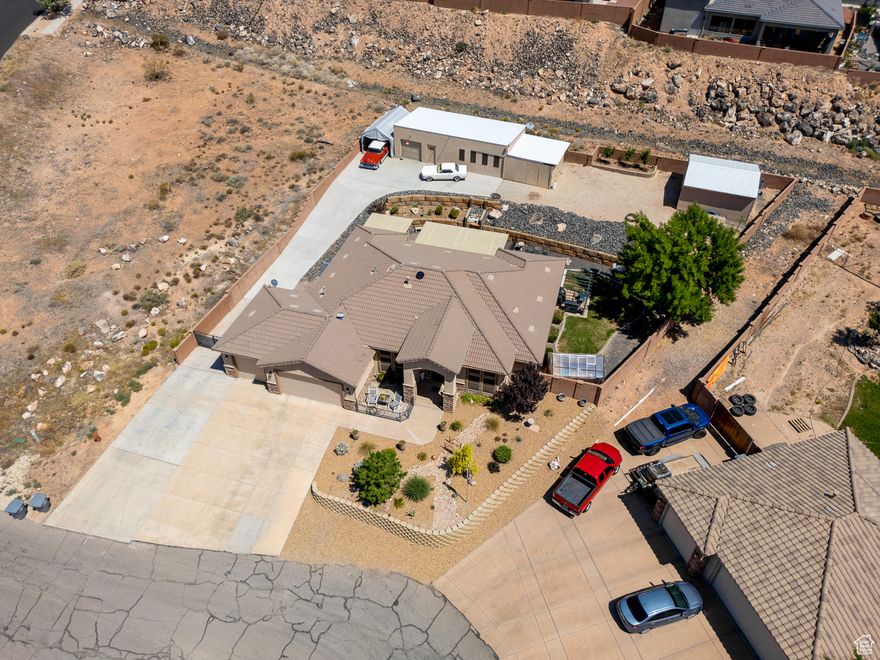 Buyer Bonus! Put this beauty under contract and receive a $1,000 credit from the seller-use it toward your closing costs or a rate buy-down. Plus, get an additional 1% of the purchase price when you finance with our preferred lender. WORKSHOP - WORKSHOP - WORKSHOP 20x40 heated and cooled plus another garage and tons of parking. This spacious .38 acre lot with Incredible Views, AND ample room for all your toys is a dream come true! This dream property is tucked away in a quiet cul-de-sac in Hurricane! The beautifully maintained 4-bedroom, 3-bath home also features a DEDICATED OFFICE-perfect for remote work or hobbies. Set on a generous .38-acre lot, the property offers breathtaking red cliff views and twinkling city lights from the backyard, creating the perfect outdoor retreat.  The xeriscaped front yard provides low-maintenance curb appeal, while the backyard includes a grassy areaideal for pets and keeping things cool in the warmer months.  You'll love the massive 20x40 workshop equipped with 100-amp service, 110/220 volt electrical, and its own mini-split system for heating and cooling. Plus, there is covered storage on the side of the shop as well as the 20x20 garage/storage building. The shop does not have water but access is close by. The HOA fee is only $22 but it is in the process of being dismantled so there will be no HOA or transfer fee. Recent upgrades include: New carpet and fresh interior/exterior paint New range/oven and microwave New patio covers Greenhouse (can stay or go) New insulation above the garage Whole house fans & solar attic exhaust fan Sealed ductwork for improved energy efficiency With TONS of parking, room to roam, and thoughtful energy-saving features, this property offers a rare blend of comfort, convenience, and functionality. Call today to schedule an appointment. It's occupied but easy to show. Buyer and Buyers agent to verify all information.