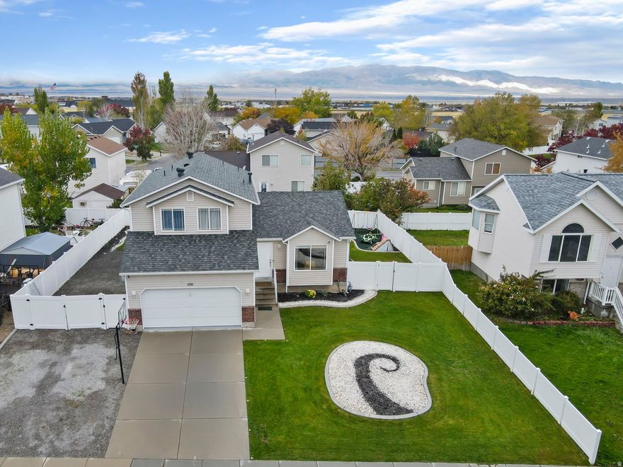 Beautiful 5-bed, 3-bath Tooele home for sale with open concept layout, fresh paint, new HVAC & roof (2024). Finished basement with flex space, epoxy garage floor, new garage motor, RV parking & $40K in landscaping. Well maintained and just minutes from Main & England Acres Park!