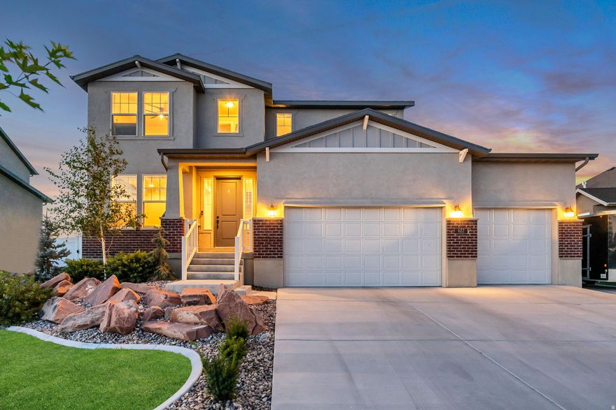 -- OPEN HOUSE SATURDAY 11AM-2PM -- Stylish upgrades, abundant natural light, and rare space for parking and storage make this Stansbury Park home stand out. Inside, you'll find luxury vinyl plank flooring, crisp white cabinetry, quartz countertops, stainless steel appliances, and charming board and batten accents that add architectural interest. The open-concept main floor is filled with natural light from large windows, creating a warm and inviting space perfect for both relaxing and entertaining. Upstairs, the spacious owner's suite offers a comfortable retreat, while the unfinished basement provides excellent storage today and exciting potential for future growth and added equity. Outside, the fully fenced backyard is ready for fun and relaxation, featuring an in-ground trampoline, gazebo, and mature peach, pear, and apple trees that produce an abundance of fresh fruit. Practical perks include RV parking with electrical hookups and a rare 3-car garage with tall ceilings, extra-deep bays, and a 220V outlet for EV charging, along with plenty of space for boats, trailers, and other recreational toys. Located in a welcoming Stansbury Park community just 30 minutes from Salt Lake City, you'll enjoy easy access to parks, the golf course, and the recreation lake, all just minutes away. Even better, the home is not located in an HOA and qualifies for 100% USDA financing, making it an even more affordable and attainable opportunity.