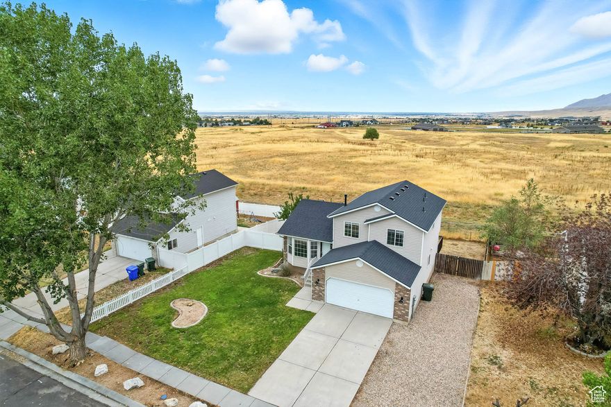 Welcome to this beautifully updated 3 bedroom, 2.5 bath home, where modern upgrades meet unforgettable views. Step inside to discover fresh paint, stylish flooring, and a brand NEW ROOF, offering true peace of mind and move - in readiness from day one. The main living areas are bright, open, and inviting, seamlessly flowing onto a spacious DECK that's perfect for entertaining or unwinding while taking in the UNOBSTRUCTED VIEWS of the valley, surrounding mountains, Great Salt Lake and Tooele County stunning sunsets.  Downstairs, the mostly above ground basement, filled with NATURAL LIGHT and offers a clean slate for your vision. With rough plumbing for an additional bath, the space is ready to become the ultimate family room, guest suite, additional bedrooms, or a home office. This home also features an ON- DEMAND (INSTANTANEOUS) HOT WATER HEATER,  ensuring you'll never run out of hot water, even with a house full of guests. An UPGRADED FILTRATION SYSTEM, adds extra comfort and can be especially beneficial for allergy sensitivity.   Outside, enjoy the convenience of RV PARKING with plenty of room for recreational toys and extra vehicles. Perfect for those who need flexibility. Conveniently located just MINUTES FROM Middle Canyon Elementary SCHOOL and Park with an exciting NINJA COURSE, WALKING TRAILS, open green space, playground and DOG PARK. Square footage figures are provided as a courtesy estimate only. Buyer is advised to obtain an independent measurement and verify all information.