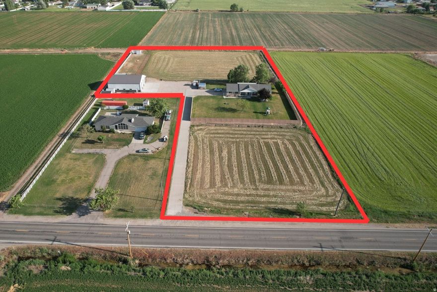 This rare 4.37-acre Hooper property blends comfortable rural living with eligible commercial rezoning-making it an ideal choice for investors, entrepreneurs, or anyone eyeing long-term potential. Flat terrain, great frontage, and easy access set the stage for a future live/work setup, small business expansion, or prime commercial development. With Hooper on the rise, opportunities like this don't last. The current 3-bed, 2.5-bath rambler offers nearly 1,850 sq. ft. of easy, single-level living, complete with an open floor plan, 3-car garage, new furnace, water heater, reverse osmosis system, remotely controlled sprinkler system, and a low-maintenance exterior. Enjoy the mountain views, covered patio, and mature trees while relaxing. And the true game-changer? An insulated and powered 50'x60' detached shop with three oversized bays (all with garage door openers)-perfect for large vehicles, equipment storage, business use, or your next big idea.