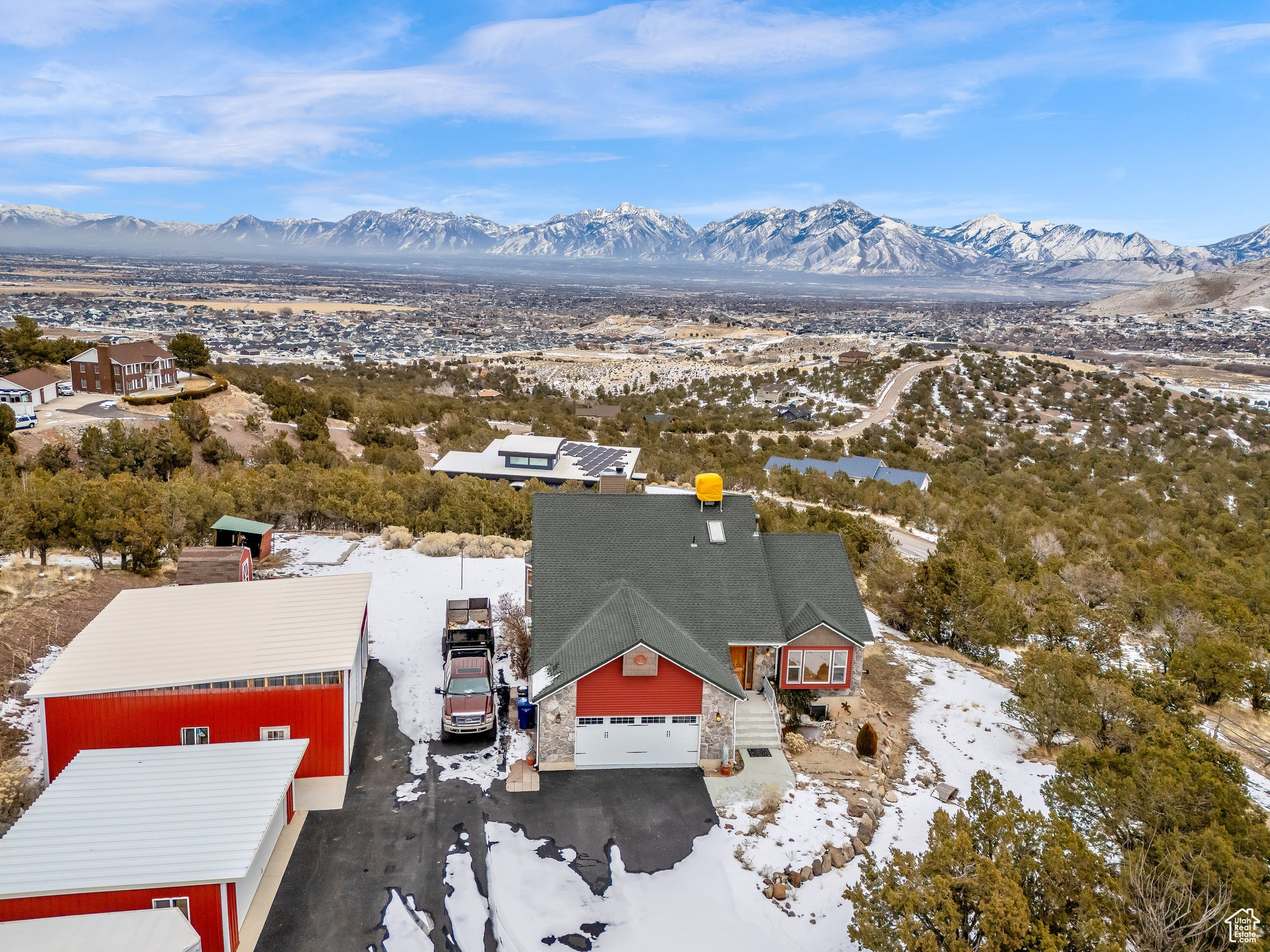 Have you ever dreamed of living high on a mountain top? At an impressive 5,640 feet in Herriman only 360 feet to the peak, this exceptional home offers a front-row seat to some of the most breathtaking views in Utah. From Salt Lake to Provo, the entire Salt Lake Valley stretches out before you, a stunning panorama of city lights, mountain peaks, and endless sky. Every morning, watch the sunrise over the Wasatch Front of the Rocky Mountains, painting the sky in shades of gold and pink as the valley below slowly wakes. In the peaceful stillness, with nothing but the crisp mountain air around you, it feels like the world is on pause. Every window in the home frames this ever-changing masterpiece, and from the expansive, completely unobstructed views from every window and deck, you can soak in the beauty without interruption. At night, as the sun dips behind the Oquirrh Mountains, the city lights begin to twinkle, stretching for miles like a sea of stars. Whether you're sipping coffee at dawn, unwinding in the evening glow, or hosting friends against this breathtaking backdrop, this home offers a connection to nature and the landscape unlike any other. A rare opportunity to own your own piece of the skyline, this home is more than just a place to live-it's a place to experience. Fenced corral for livestock is permitted here this would be a great horse property. Come see for yourself and fall in love with the view that never ends.