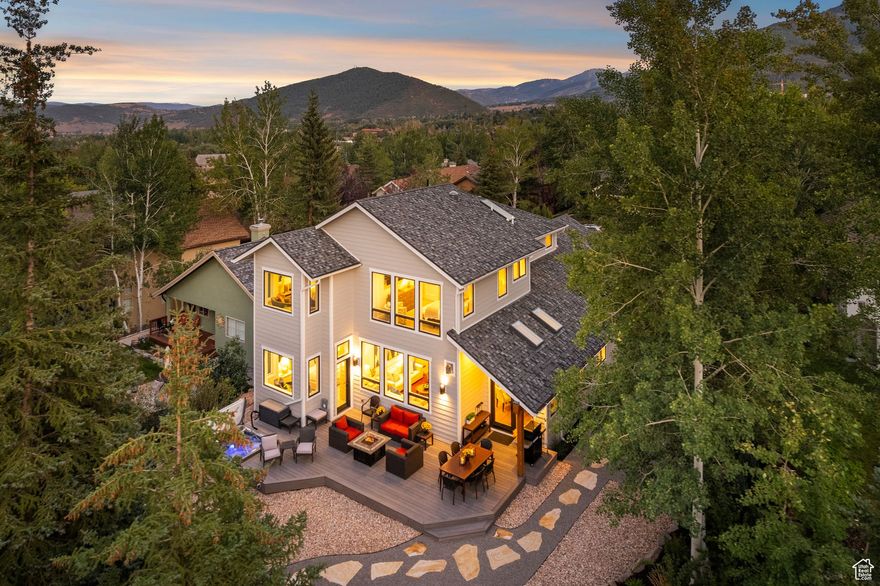 This incredible Sun Peak home located in the Willow Draw Cottages was completely rebuilt with timeless contemporary finishes and is unlike anything you've ever seen. It sits on a unique lot with the most beautiful, private backyard opening to the wooded trees with views to the back of the Utah Olympic Park with multiple seating areas and a hot tub. The great room offers two living areas both opening to the large designer kitchen while never noticing your neighbors due to the way the home is situated on the lot. There's a main floor primary suite that has been expanded making it the perfect size with a beautifully designed bathroom and walk-in closet. You'll also find another bedroom on the main floor, a spacious mud room and an impressive entrance to the home. Upstairs is a large second living area with a second full size kitchen with large windows opening to views of Deer Valley Resort and two bedrooms each with private bathrooms. The finishes and style of this home are spot-on in a timeless modern style that is both warm and contemporary. This is the best in-town home on the market in the best location.