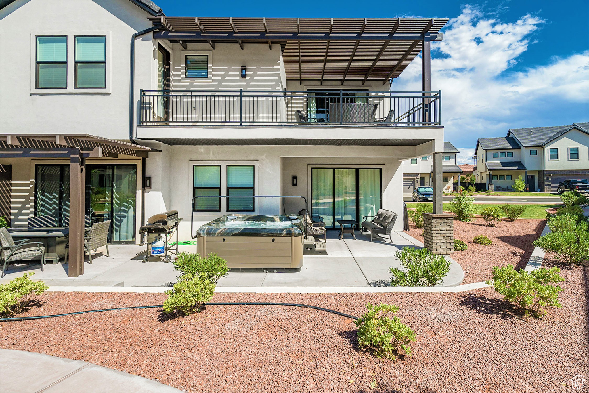 Experience the best of Ocotillo Springs Resort in scenic Santa Clara. This fully furnished 5-bedroom, 5.5-bathroom townhome offers nearly 3,000 sq ft of thoughtfully designed space, ideal for relaxing getaways or as a short-term rental investment. Built in 2020, it combines modern comfort with incredible resort-style amenities. Inside, you'll find a spacious open floor plan, designer finishes, an in-home arcade, and a private 2-car garage with an EV charging station. Step outside to your own private hot tub and BBQ area, perfect for entertaining after a day of adventure. The home is ideally located directly behind the community pool, splash pad, and pickleball courts for easy access to family-friendly fun and relaxation. Additional community amenities include a clubhouse with a pool table, ping pong, fitness center, and outdoor spa. With ample guest parking, low-maintenance living, and St. George's year-round sunshine, this home offers the ultimate desert retreat. Buyer to verify all information, deemed reliable, however buyer to verify all info including utilities, rental restrictions, and HOA information if applicable.