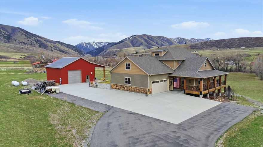 The custom timber-frame home, built in 2014, was designed with long-term comfort and efficiency in mind. The main level features 2,303 square feet of living space, with 1053 square ft on the 2nd floor and a full unfinished, insulated walk-out basement (2,272 sq. ft.) that provides room for expansion. The basement is already stubbed for an additional bathroom. A stunning 1,583 sq. ft. wrap-around porch captures sweeping views of the river valley. The gourmet kitchen is designed for both everyday living and entertaining, featuring expansive stone countertops, two sinks with disposals, abundant custom hickory cabinetry, a large walk-in pantry, and a gas range with exterior-vented hood. The open kitchen and great room showcase dramatic timber-frame vaulted ceilings, large windows that invite in natural light, and a Vermont soapstone wood-burning fireplace insert for warmth and ambiance. The spacious primary suite offers private access to the wrap-around porch through French doors overlooking the river valley and includes a large walk-in shower with dual heads and a porcelain soaking tub. Set on 8.4 picturesque acres, this exceptional property offers a rare blend of privacy, natural beauty, and thoughtfully designed living. Currently in Farmland Greenbelt, approximately 5 acres are in hay production and about 3 acres are partially wooded, featuring roughly 600 feet of live river frontage along the East Fork of the Little Bear River. Wildlife is abundant, with regular sightings of mule deer, turkeys, pheasants, sandhill cranes, and raptors such as eagles and hawks. Located just about 3 miles up the canyon from Porcupine Reservoir. The setting provides easy access to outdoor recreation while maintaining peaceful seclusion. The property includes a gated entrance, split-rail fencing, and a new asphalt driveway, with potential for horse use. Additional highlights include a large two-car garage, fenced backyard with sprinkler system using secondary water, and a high-producing well (approx. 37.5 GPM). A 30 x 40 fully insulated drive-thru RV barn/workshop, 2- 12 x 12 garage doors, south facing porch overhang. Perfect for RV, equipment, vehicles, electrical includes 220 V outlet, 3/4 bath,utility sink, elec. HWH. RV dump outside of shop.