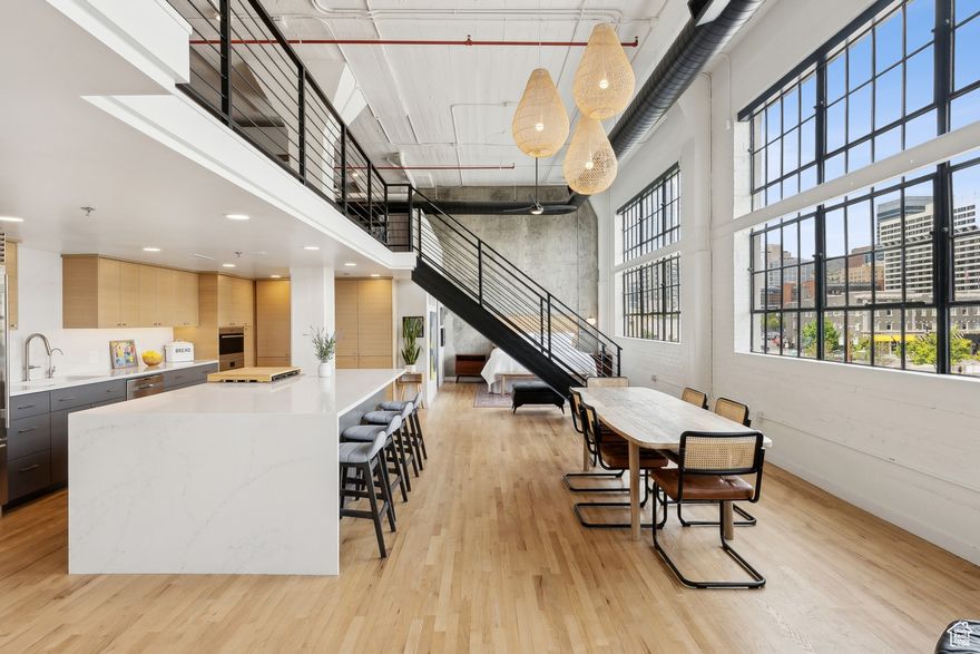 Open House Saturday 10/11 from 12 to 2pm. Experience a stunning renovation in the iconic Broadway Lofts in the heart of downtown Salt Lake City. A true luxury loft with nearly 2,000 square feet and incredible city and mountain views, this loft will provide an inspiring welcome at each arrival. Stunning gourmet kitchen with gray lower cabinets, horizontal wood grain upper cabinets, quartz countertops with waterfall edge and high end appliances including Subzero refrigerator, Wolf gas range and wall oven. Concrete construction and end walls aid in creating a quiet space. Beautifully remodeled spa-like baths. Walk-in closet with built-ins. Hardwood floors throughout. On demand water heater, reverse osmosis system plus building provides soft water. Gracious common areas with firepit, BBQ and seating areas for relaxing. Gated community with secured parking(space #33) and on site storage space complete this unit for the ultimate urban experience. Pet friendly community. All of this is just steps from Salt Lake's best entertainment, dining and shopping and less than 15 minutes to Salt Lake International Airport. Don't miss out, call for your appointment today. Buyer to verify all.