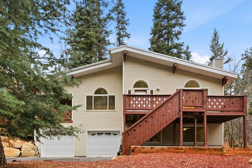 Discover this inviting 3 bedroom, 3 bathroom home nestled in the trees of Summit Park, offering just over 2,300 sq ft of tranquil mountain living. Set on a beautifully wooded lot, the property enjoys exceptional privacy while remaining conveniently accessible to both Park City and Salt Lake City. Inside, vaulted ceilings, expansive windows, and an open, airy layout bring in abundant natural light and frame serene forest views from nearly every room. The spacious great room has a bright and open feel that enhances the home's mountain charm. Multiple access points lead to an expansive wraparound deck perfect for outdoor dining, relaxing, or simply soaking in the peaceful alpine surroundings. With its generous footprint, the deck becomes an extension of the living space and a standout feature of the property. The home includes an attached two car garage, ample driveway space, and gently sloped landscaping accented by natural rock and mature evergreens. Whether enjoyed as a primary residence or a mountain retreat, this Summit Park gem offers comfort, seclusion, and the beauty of canyon living.