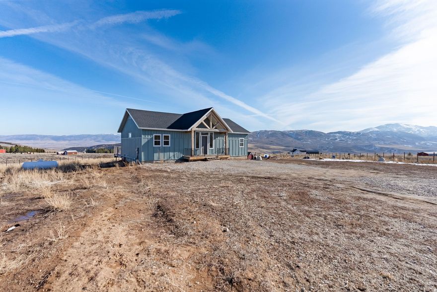 Custom-built three-bedroom, two-bath home on 2.5 acres in Elkhorn Estates. Features include vaulted ceilings throughout, including the bathrooms, large windows providing natural light, an open layout, and generous bedroom and closet space. Exterior features include a large deck, a detached storage shed with flexible use, a fully fenced property, and a beautiful arched entry. Located minutes from the Malad Summit Campground and nearby trail systems, a short drive to Devil Creek Reservoir for boating and fishing and Daniels Reservoir, a trophy fishing destination. Approximately 10 minutes from Malad City and about 35 minutes from Lava Hot Springs, with direct freeway access to Pocatello and Salt Lake City.  This home makes for a great opportunity to own a well-located property offering beautiful views, open space, and convenient access to nearby amenities and outdoor recreation. Buyer to verify all information.