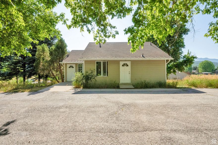 Unlock the potential of this unique Liberty property with breathtaking mountain views and a rare CV-2 commercial zoning designation. Situated on .41 acres, this versatile space offers five dedicated parking spots and endless possibilities. Once used as a dental office, it can be easily converted into a home, office, studio, or small business. The property also includes 1.75 shares of Liberty Irrigation water and one share of Liberty Pipeline's culinary water. Whether you're looking for a residence, workspace, or investment opportunity, this scenic location in the heart of Liberty is ready for your vision.