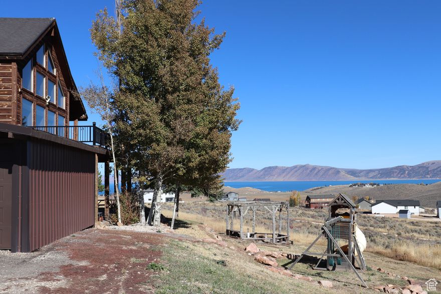 YEAR ROUND LIVING or the perfect getaway with beautiful views of Bear Lake.  Stop, you found it.  This home features a large deck with stunning views, covered patio, 2 car garage, storage sheds, fire pit and swings. That is just the outside.  Inside features 5 bedrooms, 3 baths, amazing kitchen great room with ample windows that bring in the amazing landscape and natural light. Home has a rustic feel with all the newer comforts of home.  HOA takes care of road maintenance and snow removal for year round access.