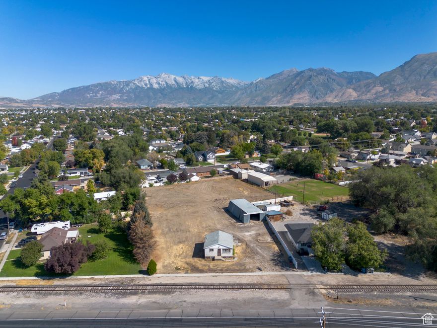 Fantastic location!!!! Centrally located in American Fork!!! Where do you find 1.46 acres in the middle of the city????  Existing home can be renovated with a total of 4 bedrooms and 2 bathrooms given current footprint. Future subdivision opportunity with additional access. Owner use with many possibilities. Existing home can also be turned into a twin home with its current zoning.  Metal outbuilding has 6+ car capacity.  Willing to trade for commercial building. Buyer to verify all information