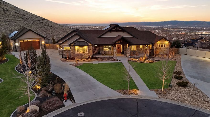 Sitting on a full acre with sweeping 180-degree views of the valley and surrounding mountains, this extraordinary estate is designed for those who value both luxury living and an active lifestyle. Offering unmatched privacy and space to entertain, the home seamlessly blends expansive indoor living with resort-style outdoor amenities.The backyard is a true retreat, thoughtfully designed for gathering and recreation. Enjoy a private pool, hot tub, outdoor shower, playground, and trampoline, all surrounded by open views and tranquility. A deck and patio that extend the entire length of the home create the perfect setting for hosting large gatherings, relaxing at sunset, or simply enjoying the breathtaking scenery. Inside, the home continues to impress with spacious and functional design. The primary suite serves as a luxurious escape, featuring an oversized soaking tub and expansive shower designed for comfort and relaxation. The home is equipped with two sets of washer and dryer hookups to accommodate busy households and guests with ease.The fully accessible guest suite in the basement provides comfort and independence, complete with wheelchair accessibility and elevator access between both floors. A variety of lifestyle spaces elevate the home even further, including a large exercise room, an imaginative playroom with a slide, and a storage room that is truly second to none.Practicality meets innovation with major upgrades such as solar panels and a reverse osmosis water system, offering remarkable efficiency for a home of this scale.The oversized garage is a rare find, large enough to accommodate two boats or three vehicles, with an additional basement level offering extensive storage or the opportunity to create a completely separate living quarter, as heat, gas, and electricity are already in place.Built with exceptional quality and thoughtful design, this remarkable property offers views from nearly every window, generous living spaces, and endless possibilities for recreation, entertaining, and multi-generational living. A home of this caliber-combining privacy, luxury, and lifestyle-is truly a rare opportunity.