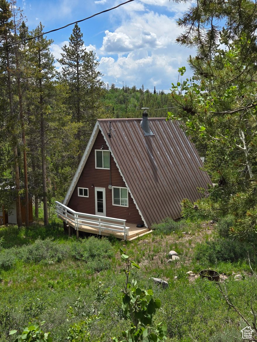 Imagine, sitting on the deck or the balcony of your cozy cabin overlooking the forest. The morning air crisp, just right for snuggling into your minky and sipping your favorite hot beverage while taking in the gorgeous vista views of the Uinta Mountains. You can make that vision a reality. Located in the Manor Lands gated community near the Christmas Meadows area of the Uinta Mountains. This cute little A-Frame will become your new happy place. It has all the necessities but is simple and keeps that cozy Hallmark movie cabin feeling. The large loft offers plenty of sleeping room, plus there is space on the lot to park a trailer or two. This property has a share of seasonal water. In the winter, the roads are plowed to the winter parking lots and groomed beyond that for snow machine access. Square footage figures are provided as a courtesy estimate only. Buyer is advised to obtain an independent measurement.