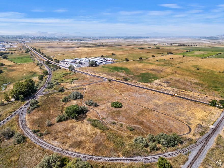 Brigham City 15.1 acres of vacant land offering exceptional development potential and direct access to I-15 / I-84. This property includes Box Elder County Parcels #03-076-0004, #03-076-0003, #03-076-0006, and #03-076-0019, providing broad frontage along Highway 13 for high visibility and easy access. Utilities are available, simplifying site development, with a possible rail spur at the south property line to support freight or maintenance activity. The parcel sits in a region with strong growth momentum and is conveniently positioned near major transportation routes, creating strong market access for commercial, industrial, or mixed-use opportunities. Don't miss this rare Brigham City land offering with substantial frontage, scalable layout, and excellent infrastructure connectivity.
