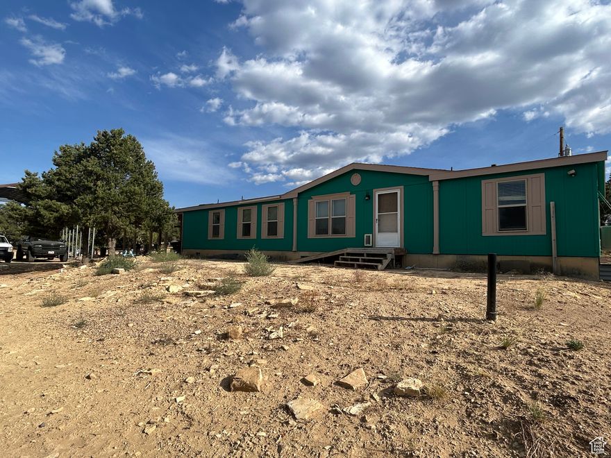 Discover peace, privacy, and endless outdoor possibilities with this spacious 4-bedroom, 1 and 3/4-bathroom manufactured home situated on a beautiful 9.82-acre lot. Surrounded by mature trees and offering year-round access. This property is ideal for full-time living, a vacation getaway, or a recreational basecamp. The home features an open, functional layout filled with natural light, open concept dining area and there is a walk in food pantry just off the kitchen. Outside there is a large covered porch-ideal for entertaining or relaxing.  There is a 1,500-gallon water cistern that is connected to the home. There is also a water well on the property, a new pump is needed to bring it into working condition. Bring your RVs, toys, and animals-there's plenty of space for parking, riding, and storing recreational vehicles, plus room for horses with flat, usable land ready for corrals or barns. No HOA restrictions.