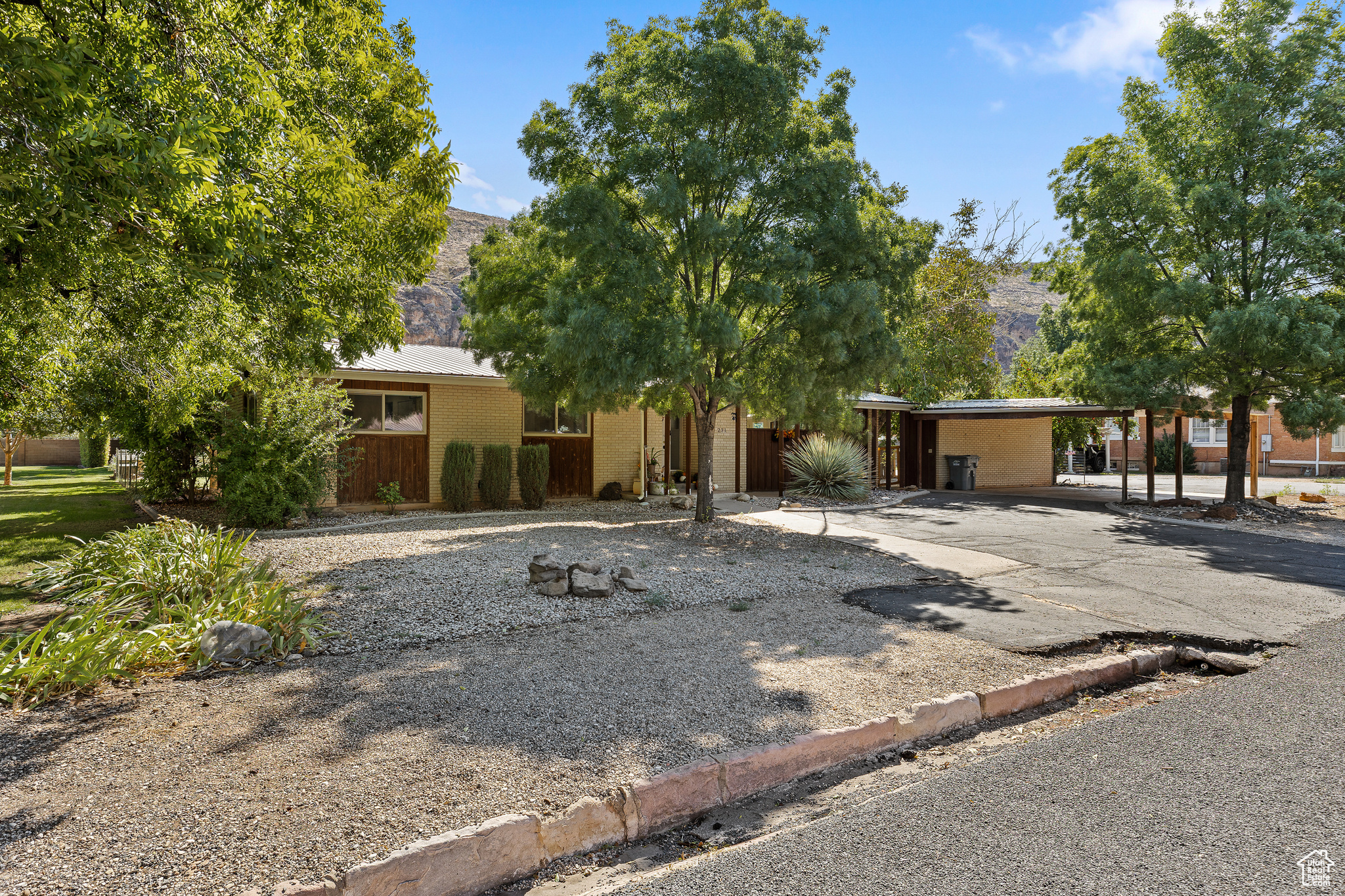 Hard-to-find downtown Hurricane home on South Main that blends nostalgic charm with thoughtful updates. Just one block from Main Street Caf, this single-level home (with a massive cold-storage basement cellar) sits on a spacious lot with no HOA or CC&Rs. Inside, recent upgrades include new carpet, fresh paint, durable LVP flooring, and recessed can lighting for a bright, modern touch. Enjoy the double-sided natural gas fireplace in the living and dining areas, a cozy wood-burning stove, built-in desks and storage, and convenient appliance/sewing closets. The home also features several new HVAC mini-split systems and some upgraded plumbing. Step outside to a fully fenced backyard with mature trees, grapevines, and fruit trees (fig, peach, plum, and pomegranate). Relax under the large covered patio with evening shade and views of the Hurricane Cliffs, or gather around the flagstone fire pit. A pull-through driveway, 2-car carport with extra storage closets, and additional parking make daily living easy. Current zoning is residential, but the property lies within the "Downtown" category of the city's General Plan Land Use Code-an area under review for future opportunities. The home is OCCUPIED, shown by appointment only. *All information is deemed reliable but not guaranteed, buyer to verify all.
