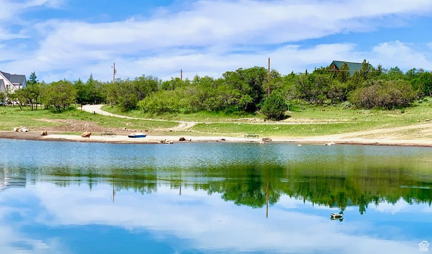 Amazing opportunity to build your dream home in the beautiful Whispering Pines subdivision. Large 1 acre lot, 4 acre community pond which is right across the street from lot, gated community, and surrounded by gorgeous views! Lot has year-round access to power and a private water system. Property facts are provided as a courtesy; Buyer to verify all information.