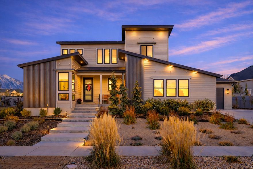 FORMER MODEL HOME in the desirable Big Willow Estates community, ideally situated on a beautifully landscaped lot with mountain views from every room. This west-facing residence offers modern curb appeal with mature trees, meticulous landscaping, including spacious afternoon shaded outdoor entertaining space, complete with a water feature, gas fire pit, garden boxes, new cedar and wrought iron fencing, and over $100,000 in exterior upgrades.  The primary floor is designed for luxury entertaining at scale, featuring an expansive open living and dining area that flows seamlessly into the kitchen and outdoors. The main level also includes a dedicated office/den, half bath, and a custom kitchen with rich white oak wooden cabinetry, an oversized island, large walk-in pantry, stainless steel Caf appliances, double ovens, double dishwashers, tile flooring, and thoughtful custom, high end finishes. Solid white oak flooring and matching window case moldings throughout the main floor and upstairs add luxurious cohesion to the space. The home includes an upgraded security system and a newly installed radon mitigation system for added safety and peace of mind.  Upstairs includes a recently upgraded primary suite with ensuite bath and separate large shower and walk-in closet, along with two additional bedrooms, a loft gathering space, a full bath, and a convenient laundry room.  The basement offers a majority finished basement with a large family room, kitchenette, one bedroom, and one full bathroom, plus a substantial unfinished area that provides flexibility for a future oversized 5th bedroom with a walk-in closet, an additional 5th full bathroom, and a second laundry area.  Additional highlights include an oversized extra-wide attached three-car garage with a charging station, central air, gas heating, sprinkler system, and outdoor landscape and home lighting, including a full home video and security system. Easy access to freeways, nearby amenities, and recreation. All appliances and most outdoor and indoor furniture is negotiable. Buyer/Broker to verify all square footage measurements obtained from county records.