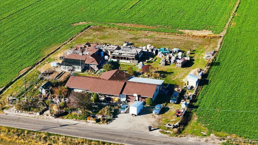 MULTIPLE OFFERS RECEIVED.  HIGHEST AND BEST DUE BY SUNDAY (11/16) AT 5PM. Welcome to "Dream Acre," a property full of heart, history, and potential. Set on 1.1 acres, this unique country setting offers open farmland views and a peaceful, rural atmosphere just minutes from the freeway. Several projects have been started throughout the home and outbuildings, offering a head start for someone ready to restore and reimagine this property's next chapter. Features include multiple outbuildings, greenhouse, garden areas, and animal enclosures: ideal for a hobby farm or small livestock setup. The property will not qualify for standard FHA or VA financing in its current condition but has excellent potential for someone with vision and a willingness to bring "Dream Acre" to life.