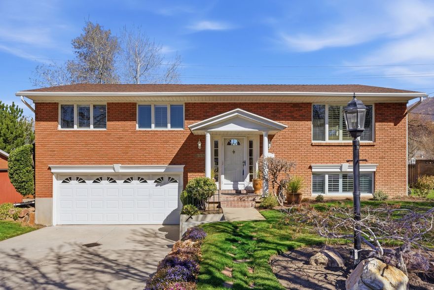 This pristine home in Cottonwood Heights has been meticulously maintained by the original owner since its purchase in 1963. It has undergone continuous updates, including a beautifully designed family room addition. Nestled on a quiet street, the home offers stunning views from the  backyard, which backs onto an open space, giving the yard an expansive feel. As you enter, you're welcomed by a light-filled living room that seamlessly flows into a spacious dining area featuring a bay window. The updated eat-in kitchen features modern cabinetry, granite countertops, and stainless steel appliances. The adjacent family room, complete with a gas fireplace and built-in bookshelves, overlooks the private backyard, where twinkling city lights can be seen in the distance. A deck off the kitchen offers ample space for outdoor dining, making it perfect for entertaining guests. On this level, you'll also find a primary suite with a 3/4 bath, along with two additional bedrooms and a full bath. The lower level features a large family room, a laundry room, a 3/4 bath, and a guest bedroom, with  an oversized attached two-car garage. The flat, well-manicured yard is beutifully landscaped with vibrant plantings and trees, and the perfect lawn space for outdoor activities. With excellent freeway access and a central location, this home is just a short drive from downtown Salt Lake, the University of Utah, ski resorts, and the Salt Lake International Airport. Square footage figures are provided as a courtesy estimate only. Buyer is advised to obtain an independent measurement.