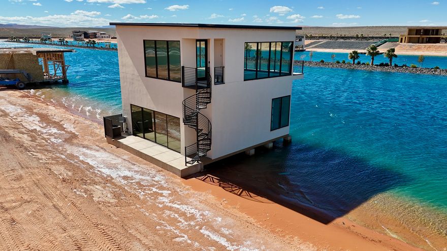 Enjoy resort-style amenities that make every day feel like vacation. The community features a private boating lake, a dedicated cable/wake lake for wakeboarding and watersports, a surf pool, and pickleball courts for fun on and off the water. Whether you're looking for a weekend escape or a place to build your ultimate lake lifestyle, this property offers the perfect blend of recreation, comfort, and opportunity. Build your dream retreat in this one-of-a-kind waterfront community designed for adventure and relaxation. This premium lot includes a private boathouse with an enclosed upper level, complete with heating and air conditioning, creating the perfect space for entertaining, relaxing after a day on the water, or designing your own lakefront getaway. The upper level is already enclosed and offers the potential to add a kitchen, allowing you to create a comfortable hangout space with incredible views.