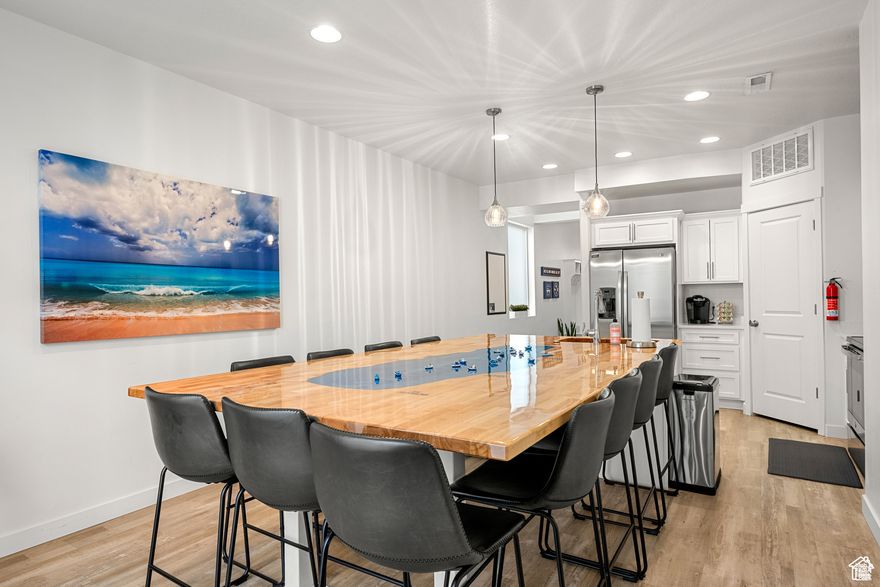 This charming end-unit townhome, within walking distance from the marina, grocery store, and local restaurants. Fully furnished, it's standout feature is the custom-built Bear Lake table, a welcoming centerpiece that sets this home apart from others in the subdivision. There is boat parking and is approved for short-term rentals.  The home is has a security system and cameras that can be operated from your cell phone, giving great peace of mind when you are far away.