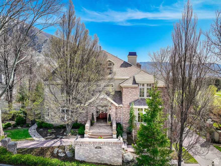 INCREDIBLE VALUE FOR THIS HOME! PRICED UNDER CURRENT APPRAISAL.  You would never be able to rebuild this all brick home with all the upgrades at this price. Seller will consider ALL reasonable offers.  This magnificent brick 2-story is nestled in the east bench foothills of the Wasatch Mountains and located on the 18th hole of the Hidden Valley Country Club golf course.  Enjoy all the amenities that Hidden Oaks HOA Community has to offer... Clubhouse, swimming pool, playground, pickle ball court, picnic area and snow removal for only $115/month! Breathtaking mountain and valley views offering privacy and serenity from every windows and off your back deck. Experience luxury living at it's finest in this remarkable home with timeless elegance. This 7100 sq. ft home is a brick masterpiece and was originally built by Steve Sheffield, a well known and respected developer for Hidden Valley. This home was personally designed and built for himself and encompasses every custom detail you can imagine. The meticulous craftsmanship is noted beginning with the exterior brick detail to the custom designs of each interior room. Not a detail was overlooked and the high-end upgrades are throughout. Note the incredible brick 3D patterns when building. The grand entry with its sweeping staircase and gorgeous marble floors, sets the tone for this amazing home. Featuring a formal front room with its turret design makes for a perfect music room and adjoining formal dining room with crown molding detail. Formal well-appointed office with gorgeous cherry wood accents and valley views. Huge gourmet kitchen that will please any chef that loves to cook and entertain. The kitchen features a very large center island and 4 chair seating. Massive countertop space and built-in cabinets for ample storage. Incredible views of the mountains and golf course from the large picture windows, polished granite countertops, oak hardwood floors, walk-in pantry, stone and travertine backsplash. Two adjacent family rooms with views. One family room has French doors walking out to the wrap around deck. Gas fireplace with a huge arched brick hearth and 2 built-in boxes for firewood storage. Cherrywood accents with recessed ceiling and lighting. Hardwood floors and crown moldings. Attached is a second family room that is used as a theater room with built-in bookshelves and entertainment center. Primary suite with adjoining sunroom and primary bath. Picture windows bringing in lots of natural sunlight. See through gas fireplace between bedroom and bathroom. Primary bath has a jetted soaking tub, double vanity, and skylight. The primary walk-in closet is gigantic with built-ins. Three additional bedrooms feature their own personality. One bedroom is the upstairs turret with dome ceiling and ceiling fan. Another bedroom is an ensuite with its own bathroom, double closets, and built-in desk area. Above ground space with high ceilings and walk-out to patio. Mother-in-law apartment with full kitchen and its own entrance. In another few weeks, the garden will transform into an English Garden Oasis. The gardens are just incredible with mature blooming shade trees, flowering perennials and bushes, ground cover, wisteria vines over trellis on upstairs wrap around trex deck, and overlooking golf course. Vegetable garden with grow boxes and drip lines. There is a downstairs covered patio for your enjoyment as well.  Elevator which makes each floor easily accessible and enjoy the separate gardener's potting room. This remarkable property offers access to nature, world-class ski resorts, recreational facilities, golfing, biking, hiking trails...all at your doorstep. Easy access to Hidden Valley Park, hike the nearby Bonneville Shoreline Trail, or Bear Canyon Trailhead to the suspension bridge. This home offers tranquility and privacy at its finest. Other special features include: TV/Audio/Speakers, attached oversized 3 car heated garage with openers. Plenty of driveway parking, workbench