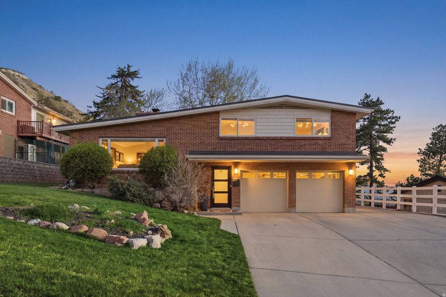 Tucked into this sought-after Mount Olympus neighborhood, this gem of a home delivers the rare combination that buyers in this zip code seek: sweeping valley and city views, a fully updated interior, and instant access to world-class outdoor recreation - all wrapped in a home that is genuinely move-in ready. Classic wood floors run through a bright, open main level accented by a sleek gas fireplace with a clean mid-mod tile surround. The kitchen has been transformed - white shaker cabinetry, quartz countertops, top of the line GE Cafe appliances, and a generous island with bar seating. Bedrooms are well-proportioned, and the bathrooms have been fully refreshed with contemporary tile and fixtures throughout. Nothing to do here but move in and enjoy. Then there's the view. As the twilight photos make abundantly clear, this home sits in a position that captures the entire valley - city lights stretching west as the sun goes down, with the rugged profile of the Wasatch Range at your back. The deck is the kind of outdoor space that becomes a daily destination year-round. This home sits moments from Mount Olympus Trailhead, Millcreek Canyon, Neffs Canyon, and Grandeur Peak Trailhead- some of the most beloved trails in the Salt Lake Valley. And when you're ready to come down from the hills, the Log Haven Restaurant in Millcreek Canyon, the local REI, and the beloved Nielson's Frozen Custard are all just minutes away.  Skyline High School, one of the highest-ranked schools in the state, is right around the corner, making this an exceptional address for families as well. A beautifully updated home, an iconic east bench location, and views that never get old.