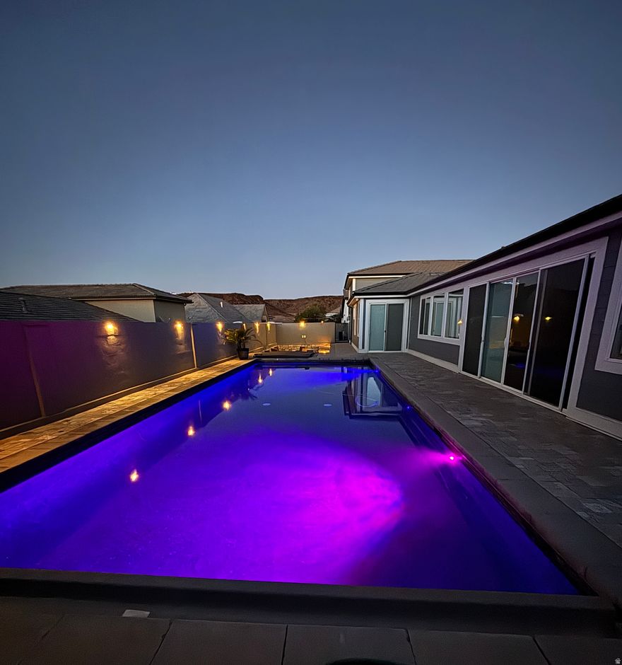 Discover your own private vacation retreat-designed for effortless relaxation and unforgettable gatherings. The saltwater sport pool with spa, swim-up bar, two fire pits, and expansive paver deck creates a resort-style oasis right at home. Inside, this modern getaway offers 5 bedrooms (each with private exterior access), 4 baths, and a bright contemporary kitchen perfect for hosting. The oversized garage easily accommodates vehicles, boats, UTVs. Also full-length of property for RV parking. Flexible layout offers optional rental potential* for those looking to offset ownership costs. Furniture package negotiable. All information & square footage figures provided as a courtesy from appraisal, tax records, and plans. Buyer to verify all data. *Restrictions may apply to short-term rentals.