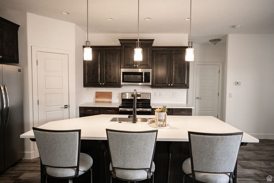 Welcome home to single level living at its finest! This beautiful home features clean lines and all the right upgrades. The kitchen is the heart of the home, featuring a large island with Quartz-Countertops, rich cabinetry and clean modern lighting that pulls everything together. You'll love the spacious Primary Suite with a beautifully tiled walk-in shower, fabulous black plumbing fixtures and a huge walk-in closet. Outside, you're right where you want to be in the heart of St. George, near biking and hiking trails, and picture perfect landscapes. Don't miss your chance to call this home yours.