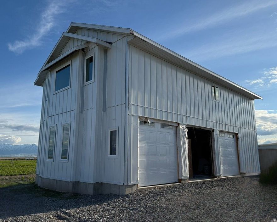 Welcome to this spacious property offering over 2,600 square feet of potential! Located on 7.8 acres of picturesque land, it offers stunning views in a peaceful setting, while still being a quick drive into Smithfield and on to Logan for more shopping and other necessities.  The property features a large three-car garage with an attached living suite, providing versatile space for living and working. It is close to completion, offering an excellent opportunity for you to personalize and finish to your liking. The property includes four water shares, a well right, a connection to culinary water, and a septic system that is already in place. Don't miss the chance to own this exceptional property with endless possibilities.