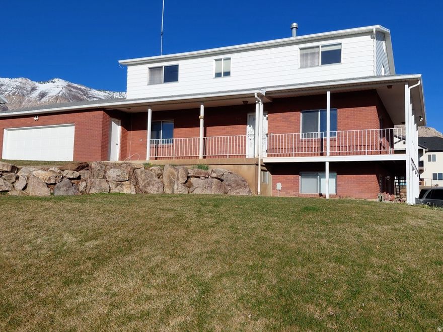 Here is a home with room for two families, the main floor has a bedroom and an accessible bathroom with a walk in tub that has its own on demand water heater. The garage is large enough for two cars and has a ramp allowing wheelchair access into the home. The top floor has three bedrooms and two full bathrooms. The basement has a full mother-in-law apartment with its' own walk out entrance to a separate driveway. The main floor kitchen appliances are all new. The carpet on the stairs, the main level and the top level is all new. The lot is large and partially fenced. The neighborhood is full of friendly neighbors. Stores, restaurants, gas stations, and the Weber County Library are one mile away.