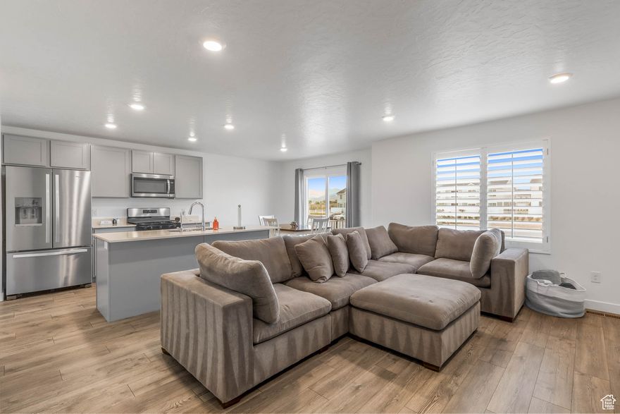 This beautiful 4-bedroom, 3-bath townhome, built in 2024 by DR Horton, still feels brand new and is truly move-in ready! Located in a fantastic community, you'll enjoy endless amenities right outside your door. A wide open green space sits directly across the street, and the brand-new community pool (currently under construction) will be just a short walk away. Other amenities include a second pool, a clubhouse, pickleball and basketball courts, a dog park, playgrounds, a splash pad, and multiple open green spaces. Plus, the location can't be beat! It's just minutes from Utah lake and hot springs, Jordan river parkway, shopping, and dining. Inside, this home is packed with upgrades and thoughtful features: plantation shutters, a 5-burner gas stove, large pantry, radon mitigation system, smart thermostat, reverse osmosis, and a doorbell with camera. It also comes equipped with a Safe Haven Security System for peace of mind. Don't miss the chance to make this home yours. Schedule your showing today before it's gone! Square footage figures are provided as a courtesy estimate only and were obtained from county records.  Buyer is advised to obtain an independent measurement.