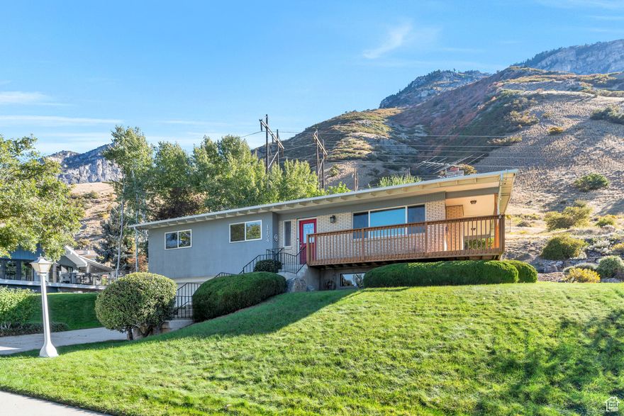 Nestled in the highly sought-after Oak Hills neighborhood, this stunning mid-century modern home offers panoramic views of Utah Lake and the surrounding mountains. Thoughtfully designed and beautifully updated, it features floor-to-ceiling windows that flood the space with natural light and showcase the incredible views. Highlights include a spacious living area with a striking stone fireplace, an updated kitchen with stainless steel appliances and a high-end refrigerator, and 5 bedrooms and 3 bathrooms-including a primary suite. The finished basement is ideal for entertaining, complete with a large family room and convenient kitchenette. Situated on a generous 0.33-acre lot, the property provides ample privacy. Conveniently located near BYU, the Wasatch Chinese Immersion Elementary School, and scenic Rock Canyon, this home offers tremendous character in a unbeatable location.