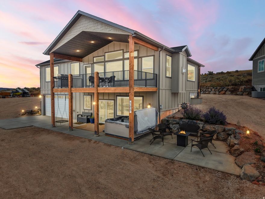 Experience refined mountain living in this stunning home overlooking the pristine waters of Bear Lake. Designed with an expansive open-concept layout, the living, dining, and kitchen spaces flow effortlessly, creating a light-filled environment ideal for entertaining and everyday living. A large covered deck and patio extend the living space outdoors, offering breathtaking lake views in every season. The heated garage, complete with a sink, provides thoughtful convenience for recreation and daily use. The spacious primary suite serves as a peaceful retreat, while the home's proven short-term rental history adds appeal for buyers seeking both lifestyle and investment potential. The property is located near Ideal Beach Resort, with a current option to purchase access to resort amenities, which now includes private beach access, swimming pools and hot tubs, pickleball courts, and additional recreational features (availability and terms to be verified by buyer). Situated on a lot with year-round road access and generous pull-through parking for boats, trailers, and recreational vehicles, this exceptional property blends comfort, design, and the lifestyle appeal of Bear Lake living.