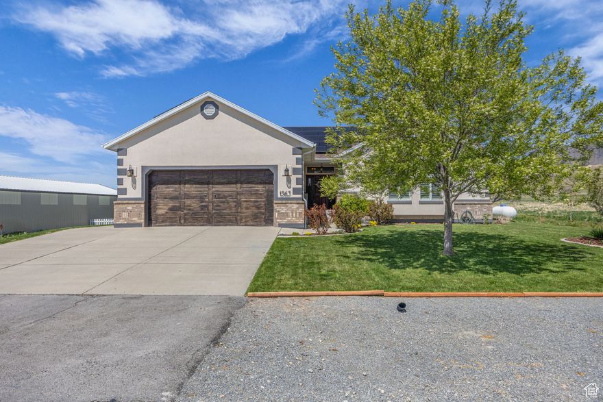 Country charm meets modern upgrades-welcome to 1563 Bryan Road in beautiful Erda, Utah! Located on the west side of the Oquirrh Mountains in peaceful Tooele County, this thoughtfully upgraded rambler is the perfect blend of quiet country living and stylish comfort.  Built to stand the test of time, the home features 12-inch polystyrene walls for energy efficiency, strength, and a whisper-quiet interior. Set on a full acre, this property also comes with 1.5 acre-feet of valuable water shares-a rare and high-demand bonus that transfers directly to you!  Need space for your hobbies, tools, or toys? You've got options: A spacious hay barn that doubles as ideal RV storage, A huge 24x60 metal building with power and a concrete floor, ready for all your projects and gear, plus, an unfinished basement with 9-foot ceilings, waiting for your vision to turn it into a dream space  And now for the upgrades (get ready, it's a long list!): Gorgeous new granite kitchen counters, Sleek new LVP flooring throughout the main level (excluding bathrooms), Updated lighting and ceiling fans, Fresh paint, baseboards, and exterior trim, A cozy new tiled fireplace, Brand new appliances: fridge, microwave, and dishwasher, Solar panels-completely paid off, JellyFish exterior decorative lighting for festive flair all year long, Matching door handles and knobs on every locking door (including the shed!), all keyed alike, New exterior lighting to brighten your evenings.  Love to garden or have backyard dreams? Eight new garden beds, A fully rebuilt chicken coop with an automatic door and rear rollout nesting box, newly planted apple and cherry trees, thriving blackberry and raspberry bushes, A charming 3-foot white picket fence to keep kids and small pets safe, and a new well pump installed just a couple of years ago.  This Erda gem is more than a home-it's a rural retreat with serious style and soul. Come experience the beauty, functionality, and freedom of country living on Bryan Road. Your dream home is waiting! All buyers must be pre-approved prior to showing!