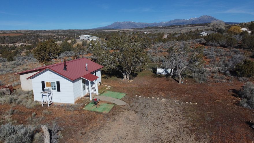 Approx 4.5 acres of breathtaking scenery featuring sweeping views of Bears Ears, Comb Ridge, Upper West Water Canyon, and others of the best landscapes of southeastern Utah. With open fields stretching to the western horizon and just around the corner from town, this property offers both serenity and convenience.  City power and a private well are in place. Included are two fully furnished homes-ready for you to move in or rent out. A charming 1-bedroom, 1-bath bungalow and a 3-bedroom, 2-bath mobile home offer current living or rental space.   Most recently both have been successfully used as short-term rentals.  Either or both could continue to be used as rentals or primary homes, and give you additional space to decide what you want to build in the future to take in the amazing setting and views.  Acreage and outlines are negotiable with room for changing what is seen in the pictures and description.  The acreage and dimensions are approximate, and subject to final survey after agreed upon contract.