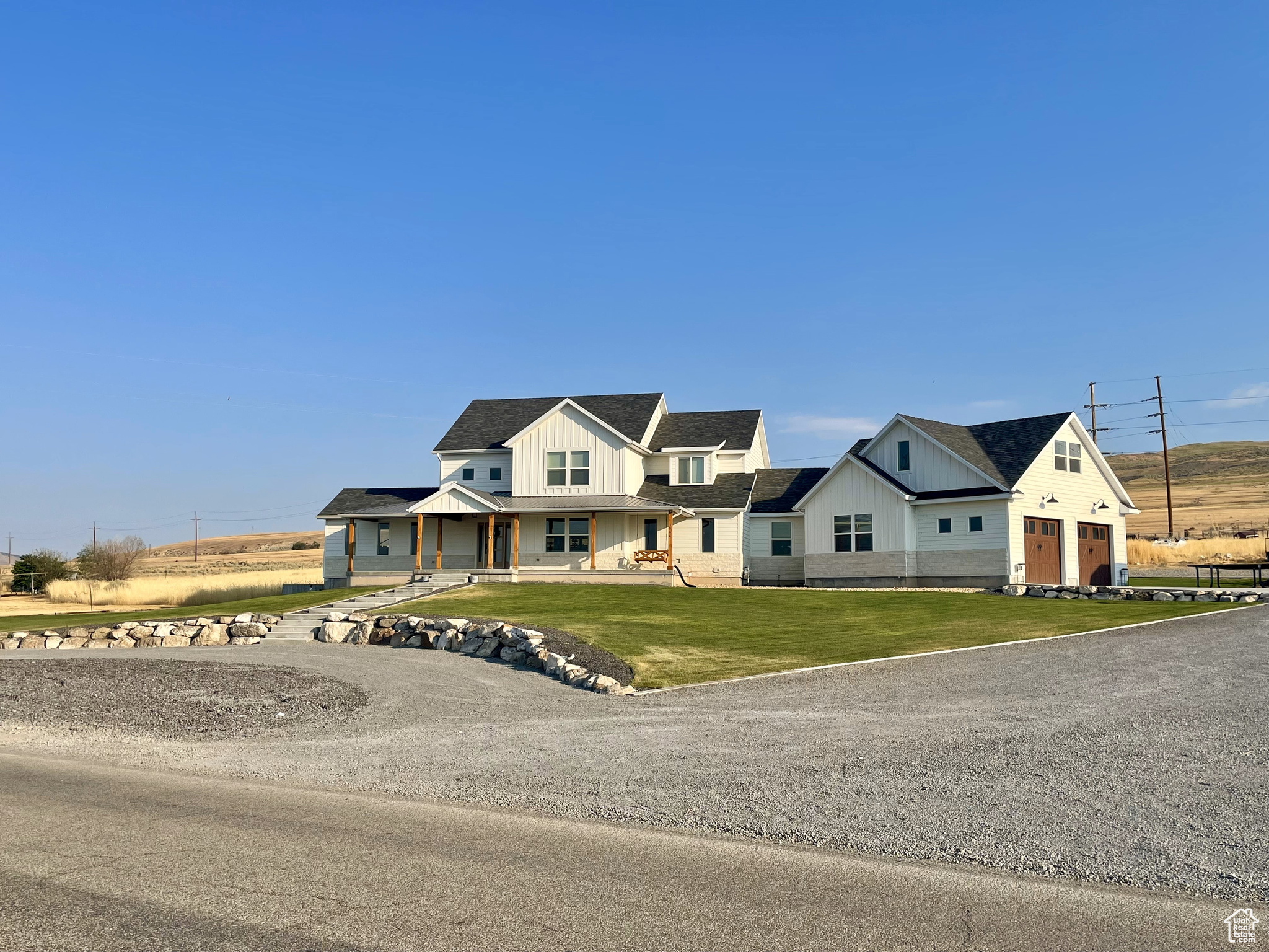 WELCOME TO YOUR MODERN FARMHOUSE, with stunning valley views! Located in Tremonton, UT. Freeway access is less than 5 minutes to both I-15 & I-84, only a 30 minute drive to Logan or Ogden, which makes country living an easy commute away! Fully finished home! Open concept living on the main floor with an 18 ft ceiling, an extra large fireplace fully rocked to the ceiling, and a 6 ft windmill fan. Vaulted sitting room with windows on all 3 sides to enjoy the views and natural lighting. Shiplap coverings and wood accents throughout the entire home. Relax and enjoy the vaulted master suite with a fireplace! Master bath boasts a large walk-in, double shower, a free standing soaker tub, and a HUGE walk-in closet! The upstairs features bedrooms with beautiful views! In the basement you'll walk into a large family room with a theatre, wet bar, and more wood and brick accents! Walk-in closets in the basement bedrooms, a walk out basement access, and plenty of storage in the vast storage room. A 500 sq ft mother in law apartment or VRBO rental is located above the garage, with its own separate exterior entrance! Situated on 1.43 acres with a 30x50 shop, an abundance of storage on a 200 sq ft mezzanine inside the shop as well as a 200 sq ft finished gym! Come and see all the custom upgrades this home has to offer! Buyer to verify all information.